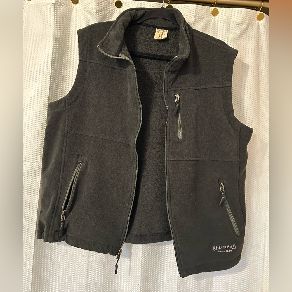 Red head black vest